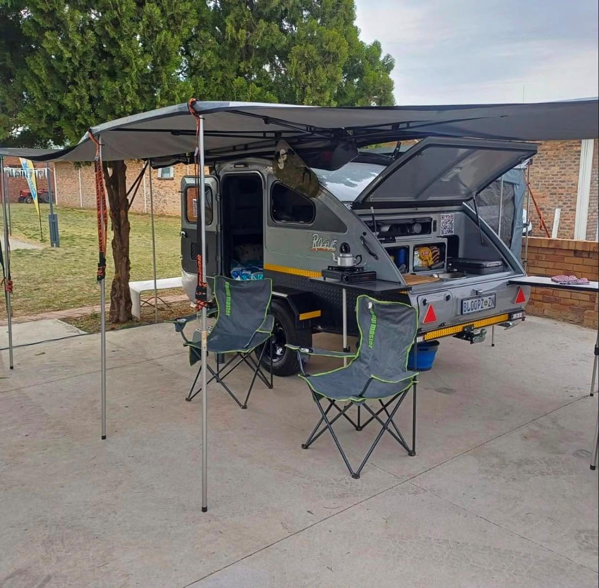 Rear view of camper trailer camping setup