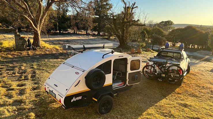 Camper trailer campsite setup with chairs