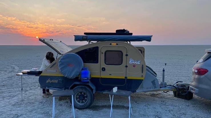 Camper trailer campsite setup with chairs