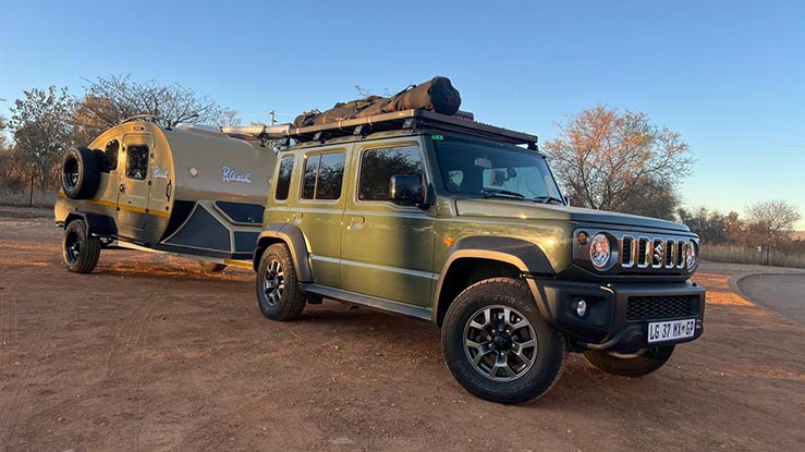 Camper trailer campsite setup with chairs