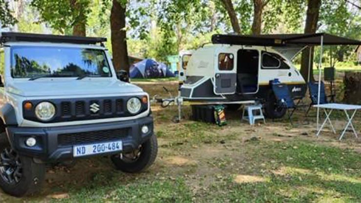 Camper trailer campsite setup with chairs